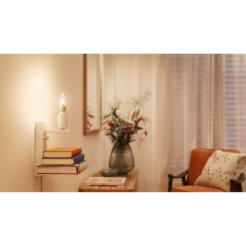 LED-Lampe beleuchtet Bücherstapel auf Wandregal