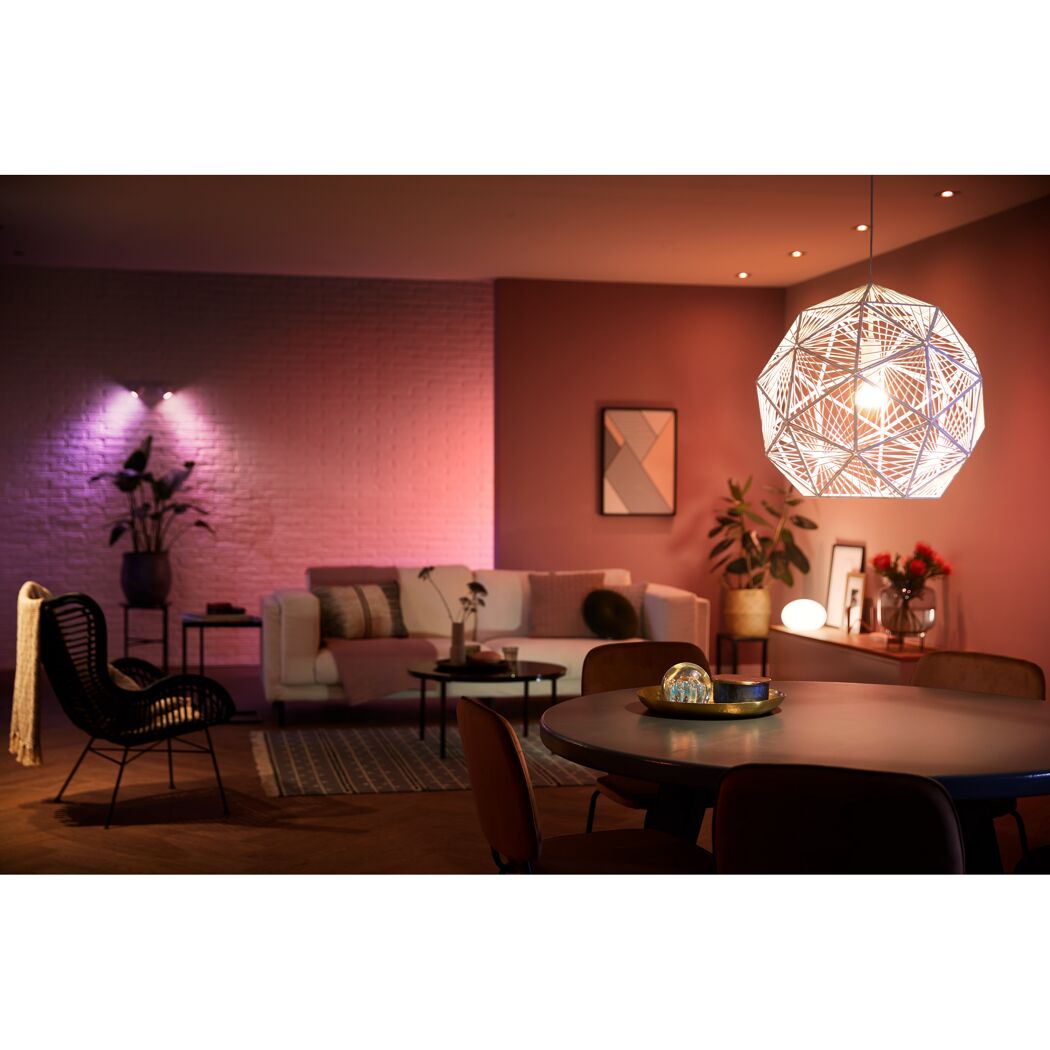 Wohnzimmer mit dekorativer Pendelleuchte und bunter Beleuchtung.