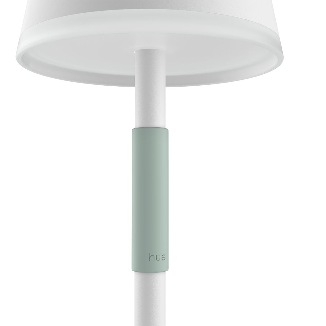 Weiße Philips Hue Tischleuchte Go mit mintfarbenem Band.