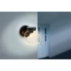 Schwarze runde Wandleuchte an Wand