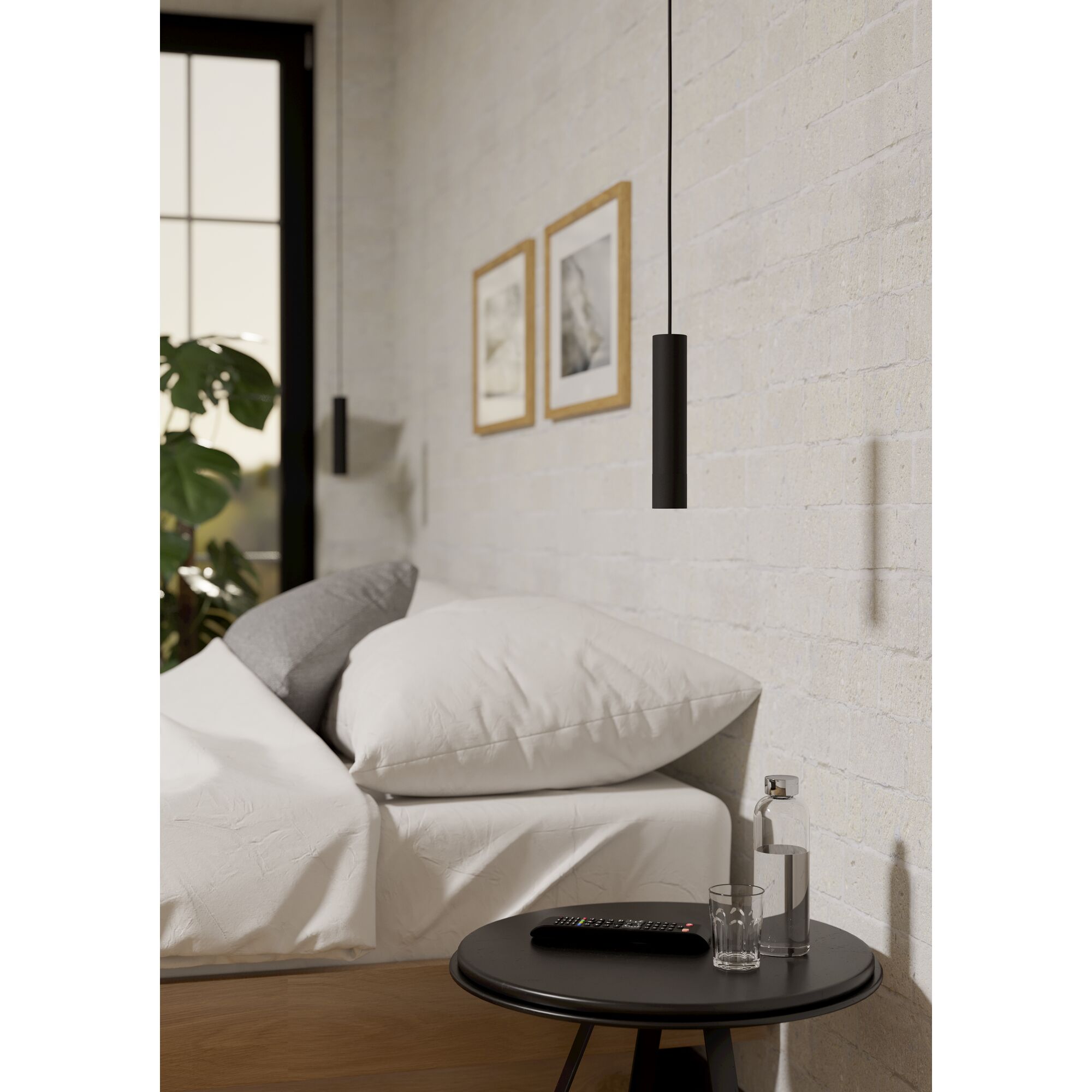 Schwarze Pendelleuchte über Nachttisch
