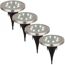 Vier beleuchtete silberne LED-Solar-Bodenstrahler.