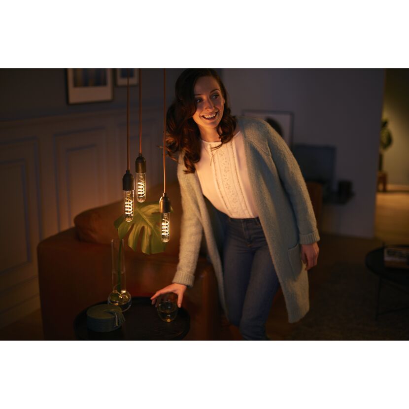 Person in einem Wohnzimmer mit LED-Lampen