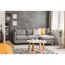 Wohnzimmer mit grauer Couch, beigen Kissen und rundem Couchtisch